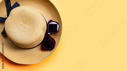 Sunglasses with summer hat on orange background. Enjoy holiday concept.