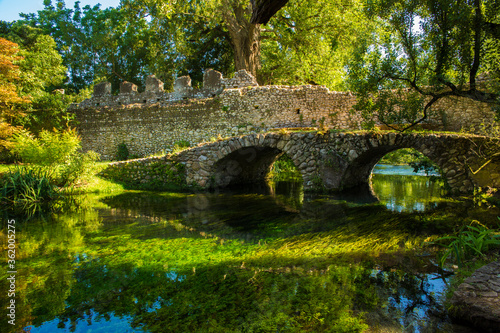 View of the Roman bridge of Ninfa, an ancient medieval town located in the province of Latina, Italy. Now it is part of the complex of Ninfa gardens.