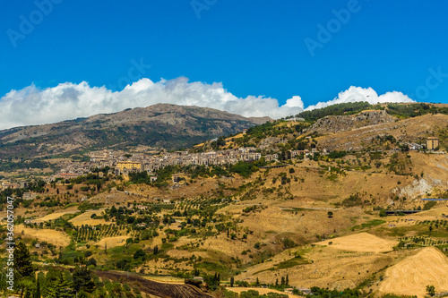 The hilltop village of Petralia Sottana against the backdrop of the Madonie Mountains, Sicily during summer