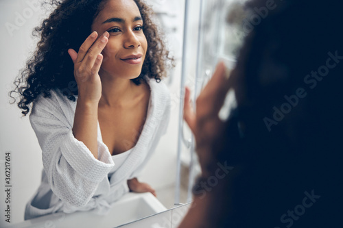 Beautiful woman staring at herself in the mirror
