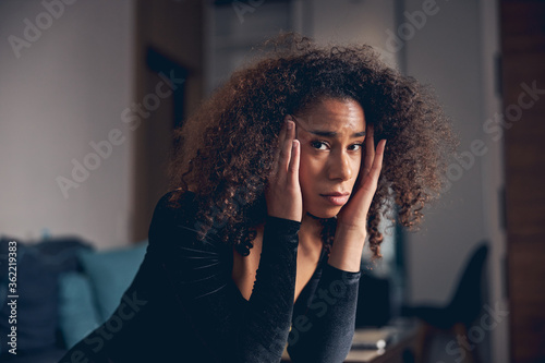 Dejected African American woman having a headache