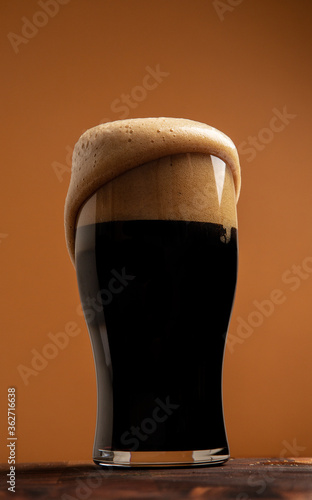 Overflowing stout in a shapely pint glass 