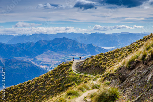 Roys Peak mountain hike in Wanaka New Zealand. Popular tourism travel destination. Travel and adventure New Zealand landscape background. 