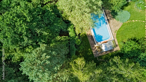 Aerial top view of swimming pool in beautiful garden 