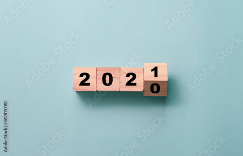 Flipping of wooden cubes block to change 2020 to 2021 year. Merry Christmas and happy new year concept.