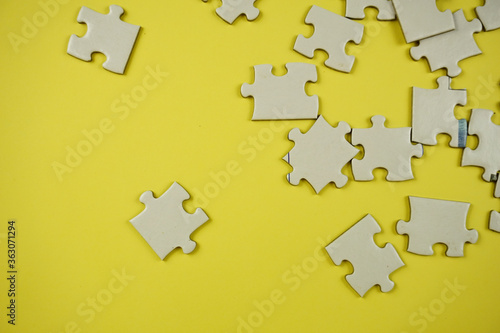 random jigsaw puzzle incomplete concept on yellow background