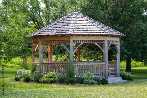 Scenic rural tree lined landscape with wooden gazebo