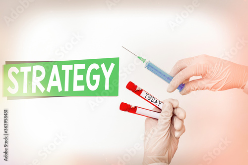 Word writing text Strategy. Business photo showcasing action plan or strategy designed to achieve an overall goal Extracted blood sample vial ready for medical diagnostic examination