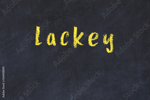 College chalk desk with the word lackey written on in