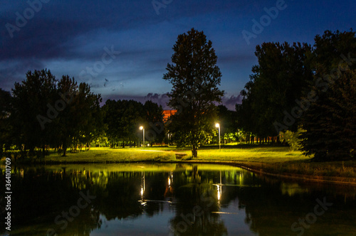 Night summer European park with river and promenade