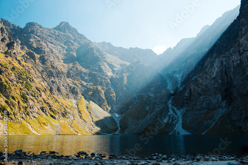 Morning sky with sun lights over Morskie Oko lake