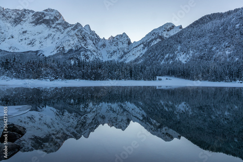 Lake lago di Fusine Italy winter snow water reflection mountains alps