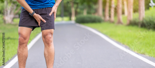 Young adult male with muscle pain during running. runner have leg ache due to Groin Pull. Sports injuries and medical concept