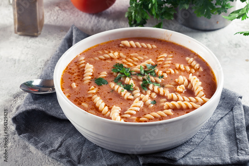 Tomato soup with fusilli pasta in the bowl