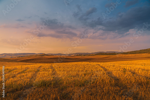 Magnificent summer sunset over Tuscany fields and hills