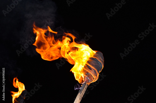 Burning flame torch in night during an event