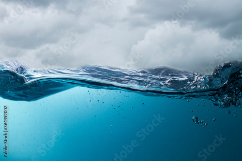 The deep blue sea at the time of the storm can be seen from under the water. Abstract wave blur under water