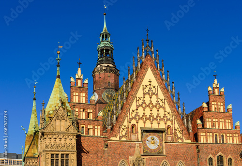 Sightseeing of Wroclaw, Poland. City hall of Wroclaw - the monument of architecture in the Gothic style. Detail of the facade with an astonomical clock.