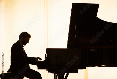 Silhouette of pianist performing