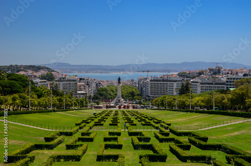 View of the labyrinth of Eduardo VII park and gardens, the largest park in the center of Lisbon, prolonging the main avenue (Avenida da Liberdade) and Tagus river in the background, in Portugal.