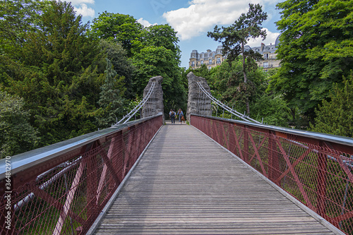 63-meter-long suspension bridge (1867) in Buttes-Chaumont Park (Parc des Buttes-Chaumont, 1867) - Public Park situated in northeastern Paris, fifth-largest park in Paris. Paris. France.