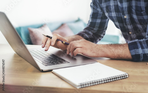 Male student studying online using laptop. Online education concept