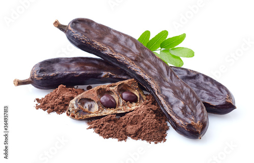 Carobs beans with leaves on white background