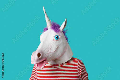man wearing a unicorn mask