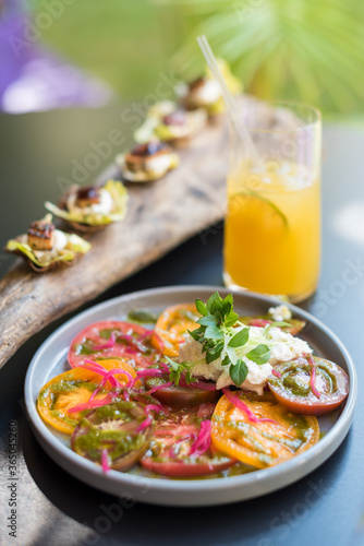 Heirloom Tomato and Cream Cheese Salad with Red Onion and Basil. Summer Appetizers and Beverage