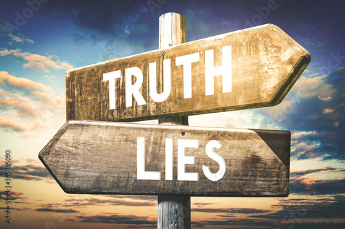 Truth, lies - wooden signpost, roadsign with two arrows