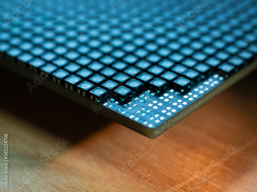 Closeup of corner of an LED video screen with shallow depth of field and some emitters removed