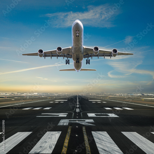 Airplane taking off from the airport runway, front view