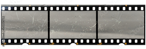 original 35mm filmstrip with empty dusty frames or cells and nice texture on the border, fluffs on film material, real film grain.