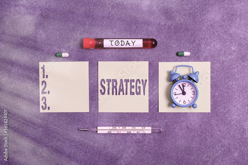 Writing note showing Strategy. Business concept for action plan or strategy designed to achieve an overall goal Blood sample vial medical accessories ready for examination
