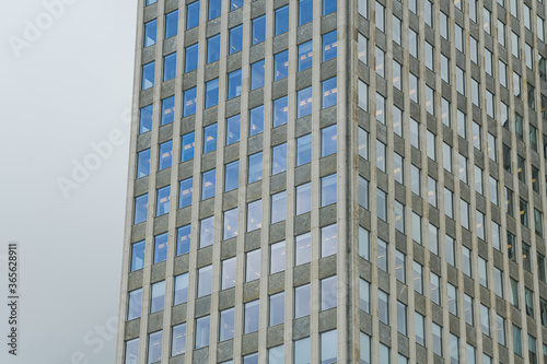 Windows of an office building with sky reflection during a cloudy day