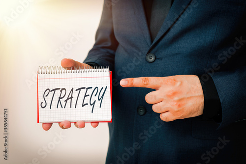 Handwriting text Strategy. Conceptual photo action plan or strategy designed to achieve an overall goal Model displaying different empty color notepad mock-up for writing idea