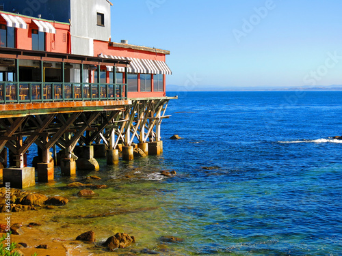 Restaurants and a rocky beach at Cannery Row, in Monterey bay, California. Historic 700 Cannery Row Mall, Beach, Monterey.