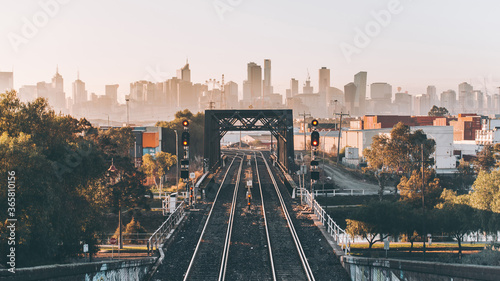 City skyline at sunrise with train line 