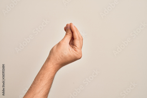 Hand of caucasian young man showing fingers over isolated white background doing Italian gesture with fingers together, communication gesture movement