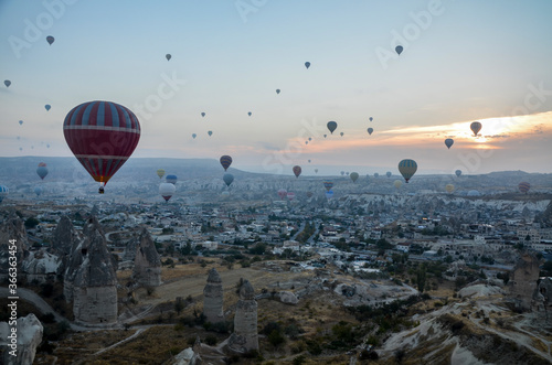 Colorful Hot air balloon flying over rocks and valley landscape at Cappadocia near Goreme Turkey