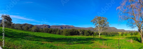 Panorama southern highlands Kangaroo Valley and Berry country town lush green pastures blue skies