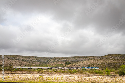 Terrell County, Texas / United States - June 2, 2020: The Amtrak Sunset Limited train travels through the desert near Sanderson, Texas.