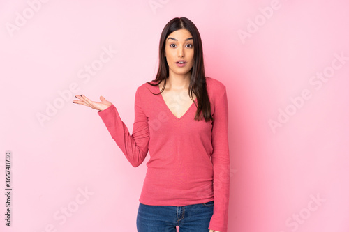 Young caucasian woman over isolated background making doubts gesture