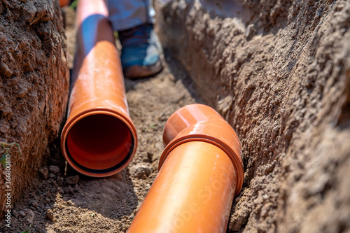 laying drainage pipes into the ground