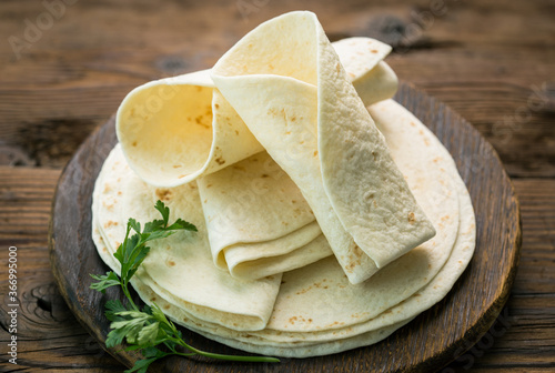 Whole wheat flour tortilla on the wooden table background 