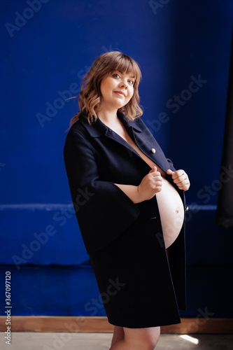 Topless, beautiful pregnant with overweight in a blue jacket.