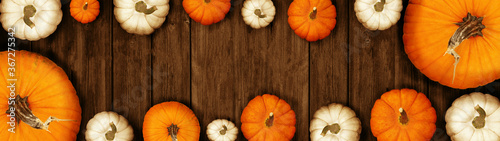 Happy Thanksgiving banner background panorama - Autumn Holiday Harvest still life, Set of various pumpkins on dark wooden table background. Autumn vegetables and seasonal decoration, top view