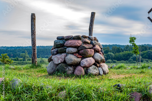 Stone altar in nature on bright sunny day, near water