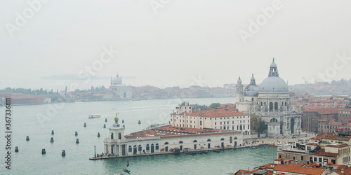Panorama view from San Marco campanile on Venice Grand Canal, Basilica di Santa Maria della Salute in cloudy weather, Italy