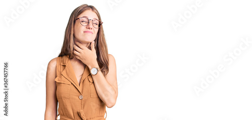 Young beautiful blonde woman wearing casual clothes and glasses touching painful neck, sore throat for flu, clod and infection